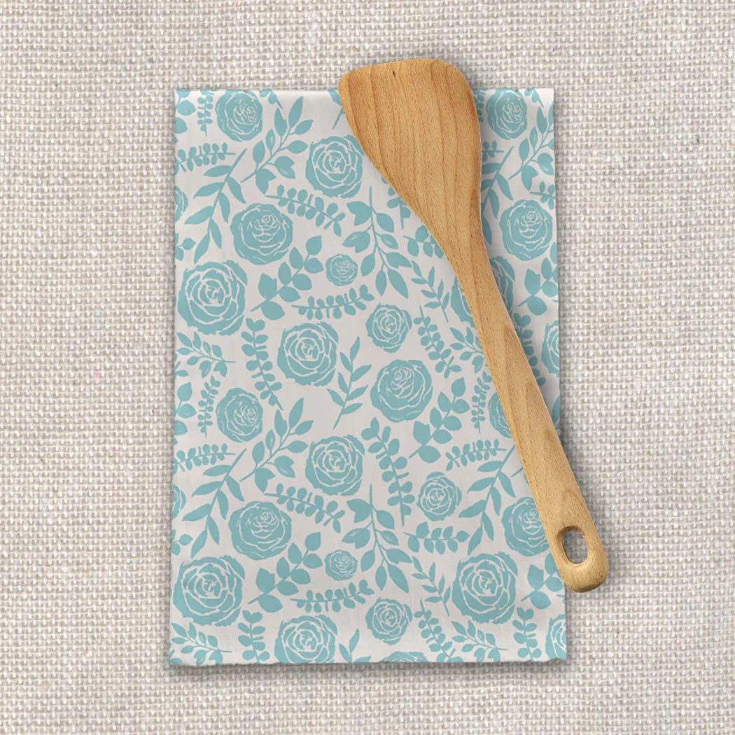 Floral teal kitchen towel with wooden spatula on neutral fabric, Qu!rk Boutique gift