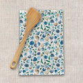 Wooden spatula on floral blue and green tea towel, eco-friendly kitchen decor at Qu!rk Boutique
