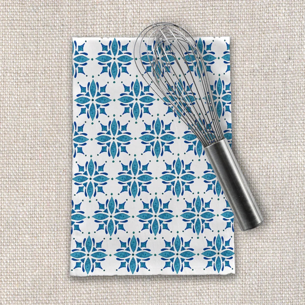 Blue floral patterned tea towel with metal whisk on textured fabric, Qu!rk Boutique kitchen gift.