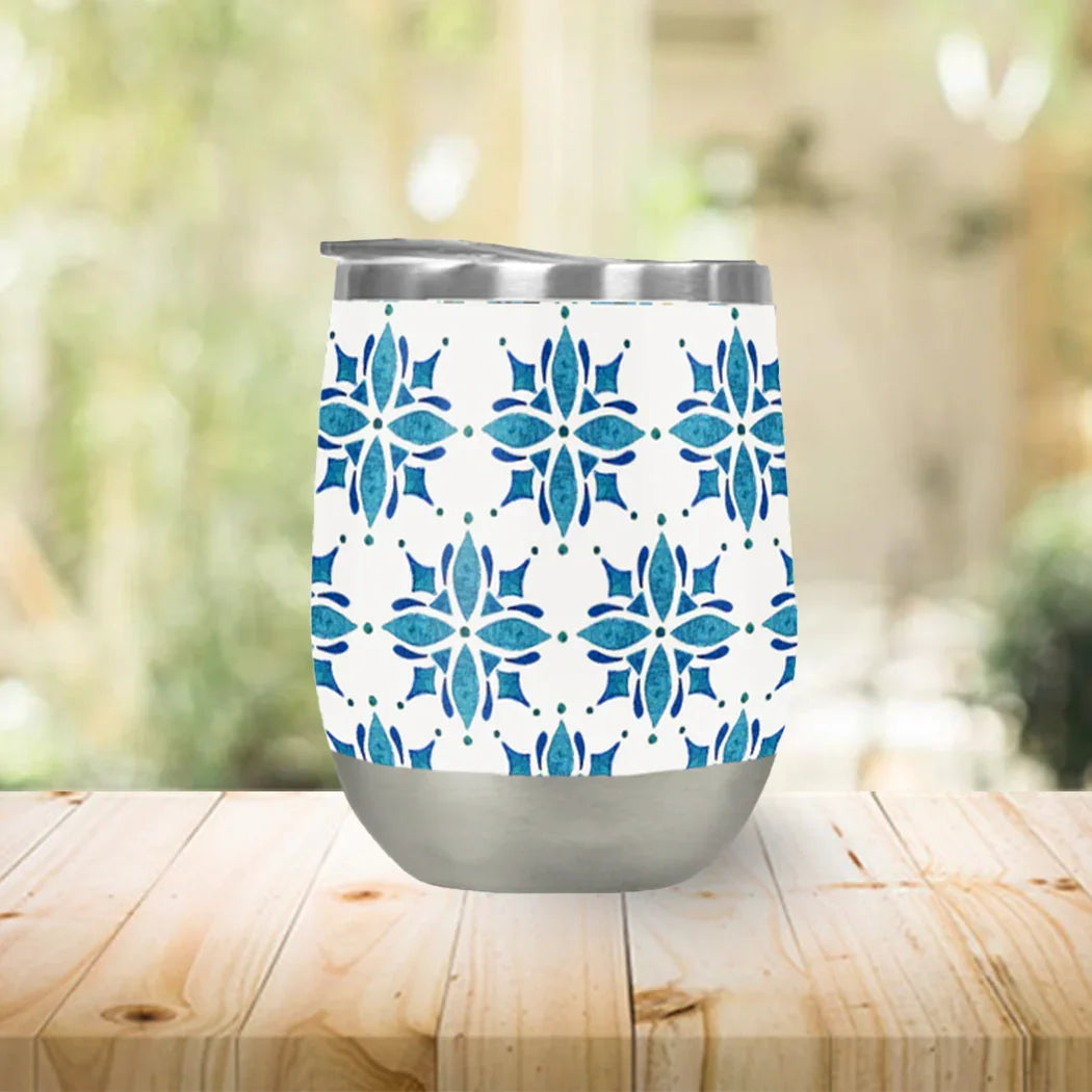 Blue floral patterned insulated tumbler on wood table, Qu!rk Boutique artist-designed gift