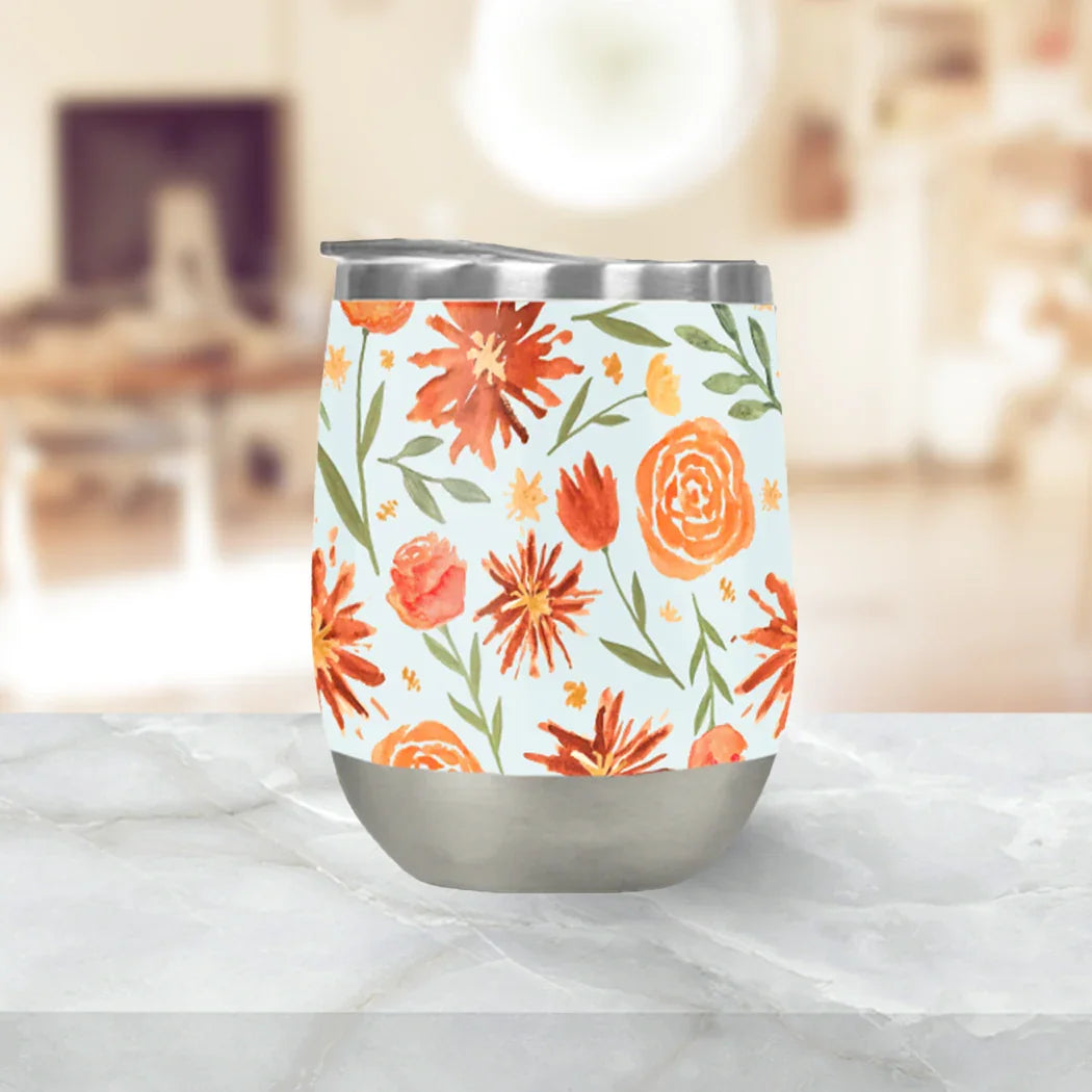 Stainless steel tumbler with orange floral pattern on marble table, Qu!rk Boutique home décor