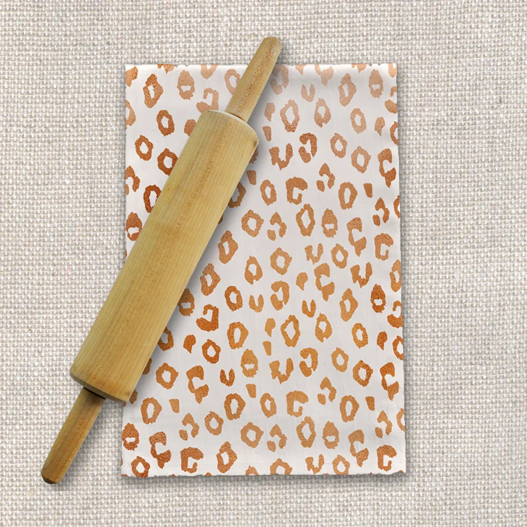 Wooden rolling pin on leopard print paper with linen background, Qu!rk Boutique style