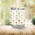 Gold floral-pattern tumbler cup on wooden table, Qu!rk Boutique eco-friendly artist gift