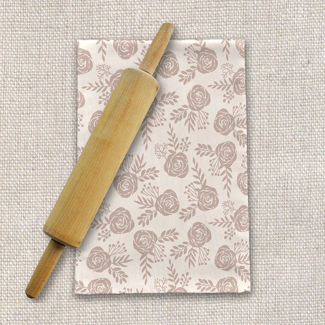 Wood rolling pin on rose floral tea towel, neutral linen texture, Qu!rk Boutique kitchen decor