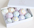 Box of 12 colorful Lizush natural bath bombs in various scents including eucalyptus, lemongrass, and lavender