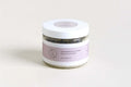 Jar of Lavender Body Scrub with white lid and purple label on neutral background