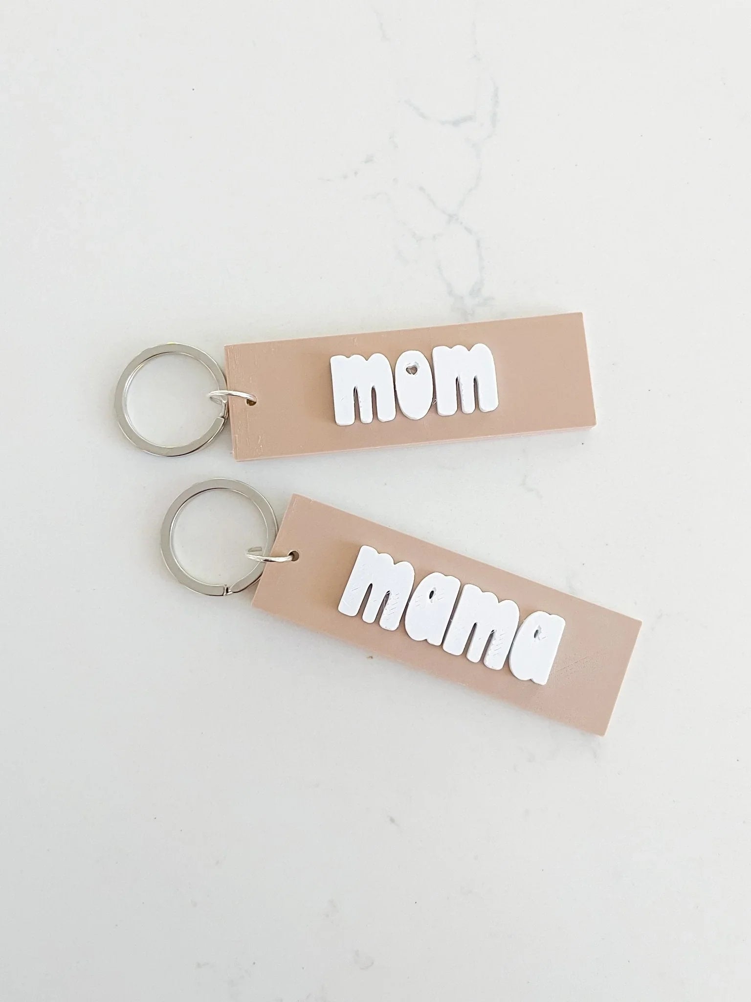 Neutral pink mom and mama keychains with white bold letters on a light background, Qu!rk Boutique gifts