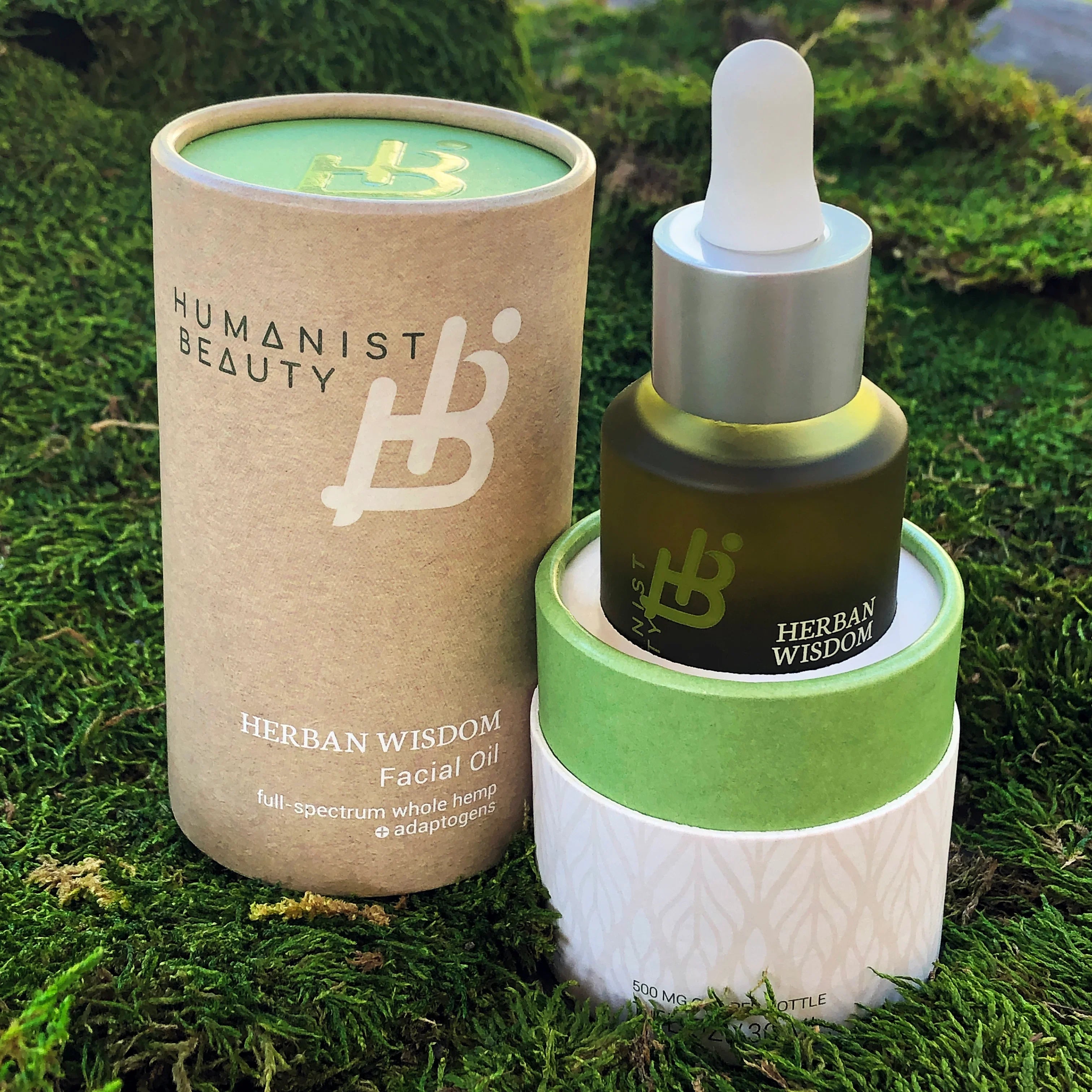 Humanist Beauty Herban Wisdom Facial Oil on green moss, eco-friendly skincare at Qu!rk Boutique