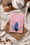 Book titled How to Give Your Clothes a Second Life on wicker mat with glasses, candle, succulent, and dried orange slices