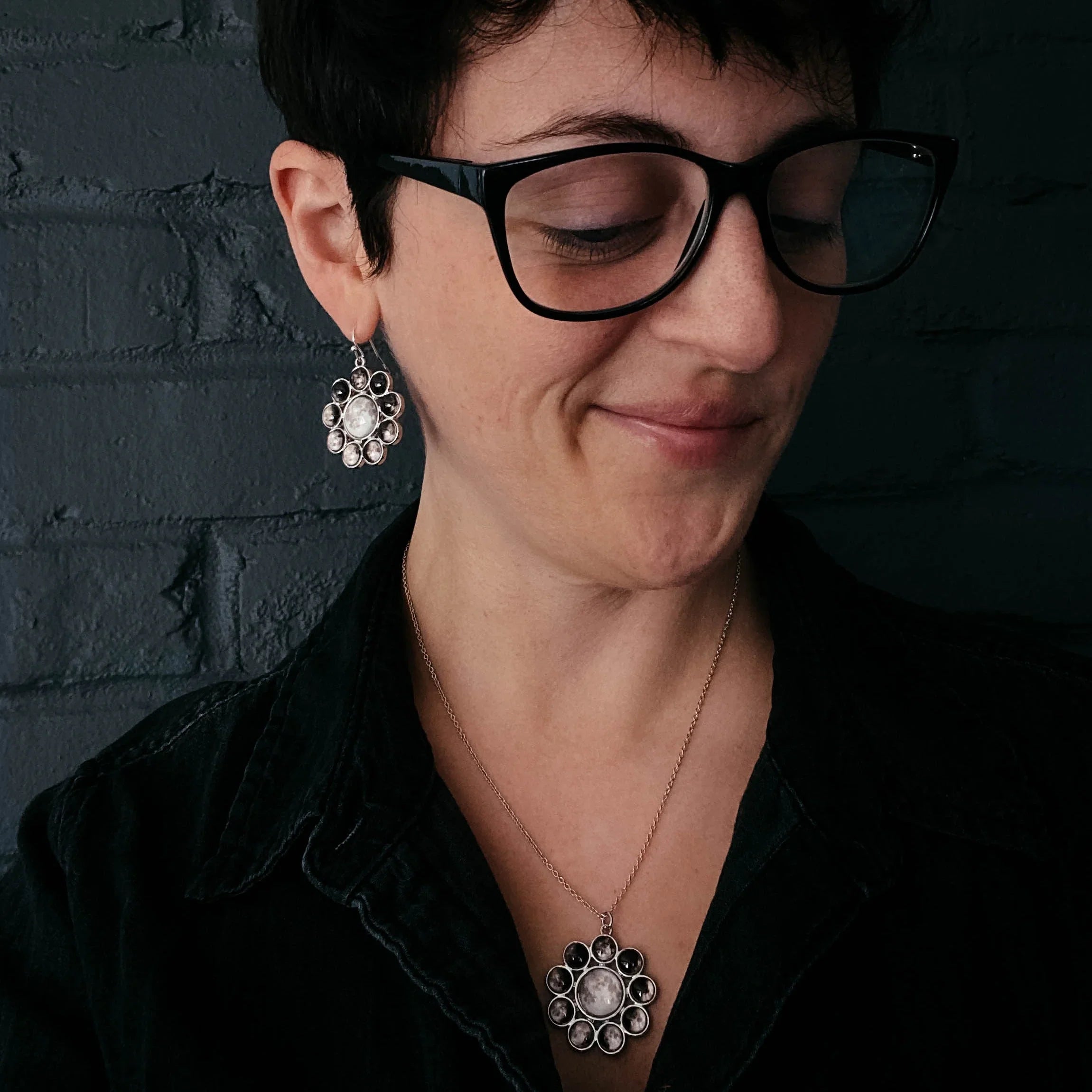 Woman wearing moon phase halo pendant necklace and earrings, cosmic jewelry from Qu!rk Boutique