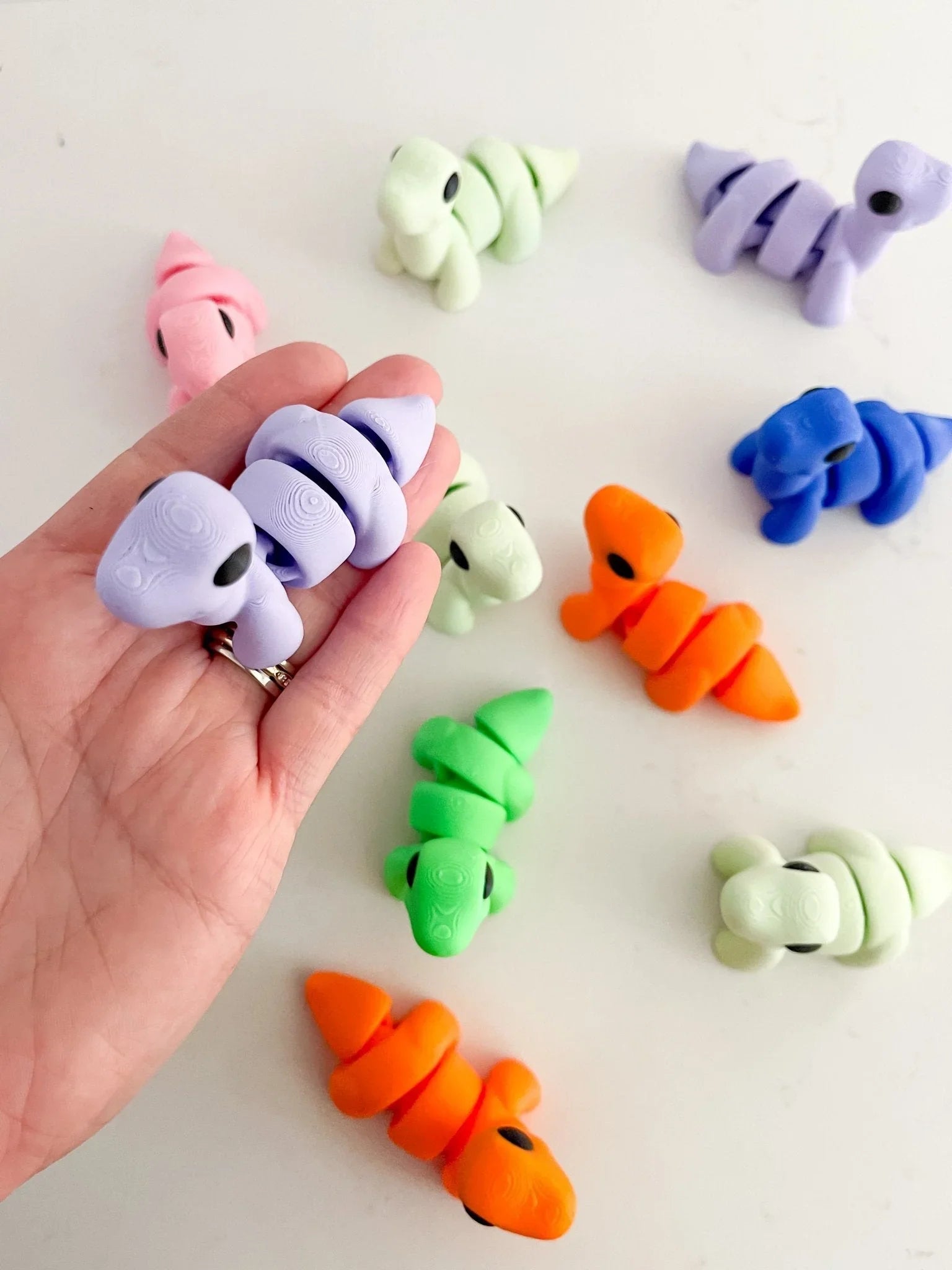 Colorful segmented baby critter toys in pastel and neon shades from Qu!rk Boutique Gift Shop