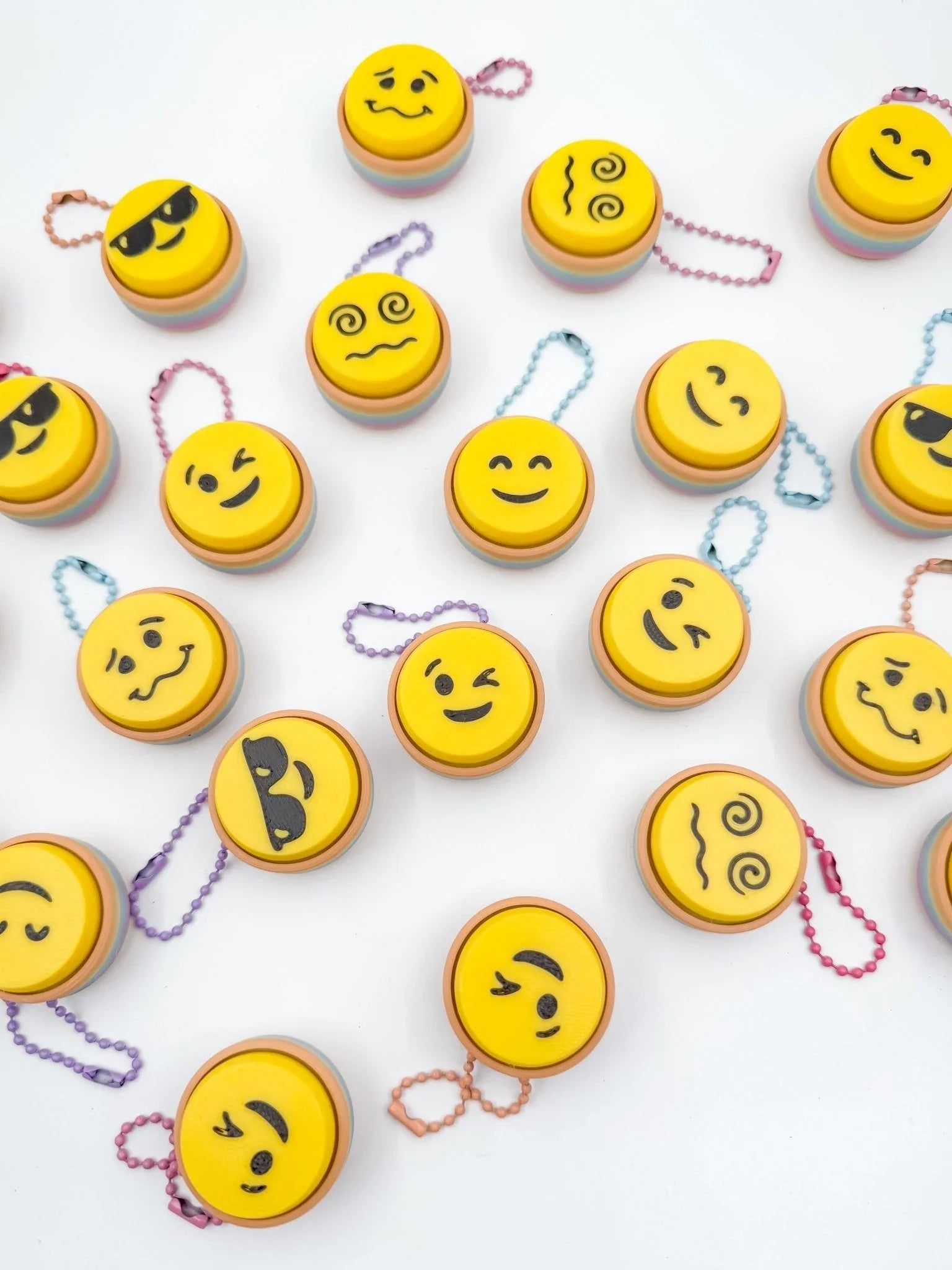 Colorful emoji keyboard clicker keychains arranged on white background from Qu!rk Boutique