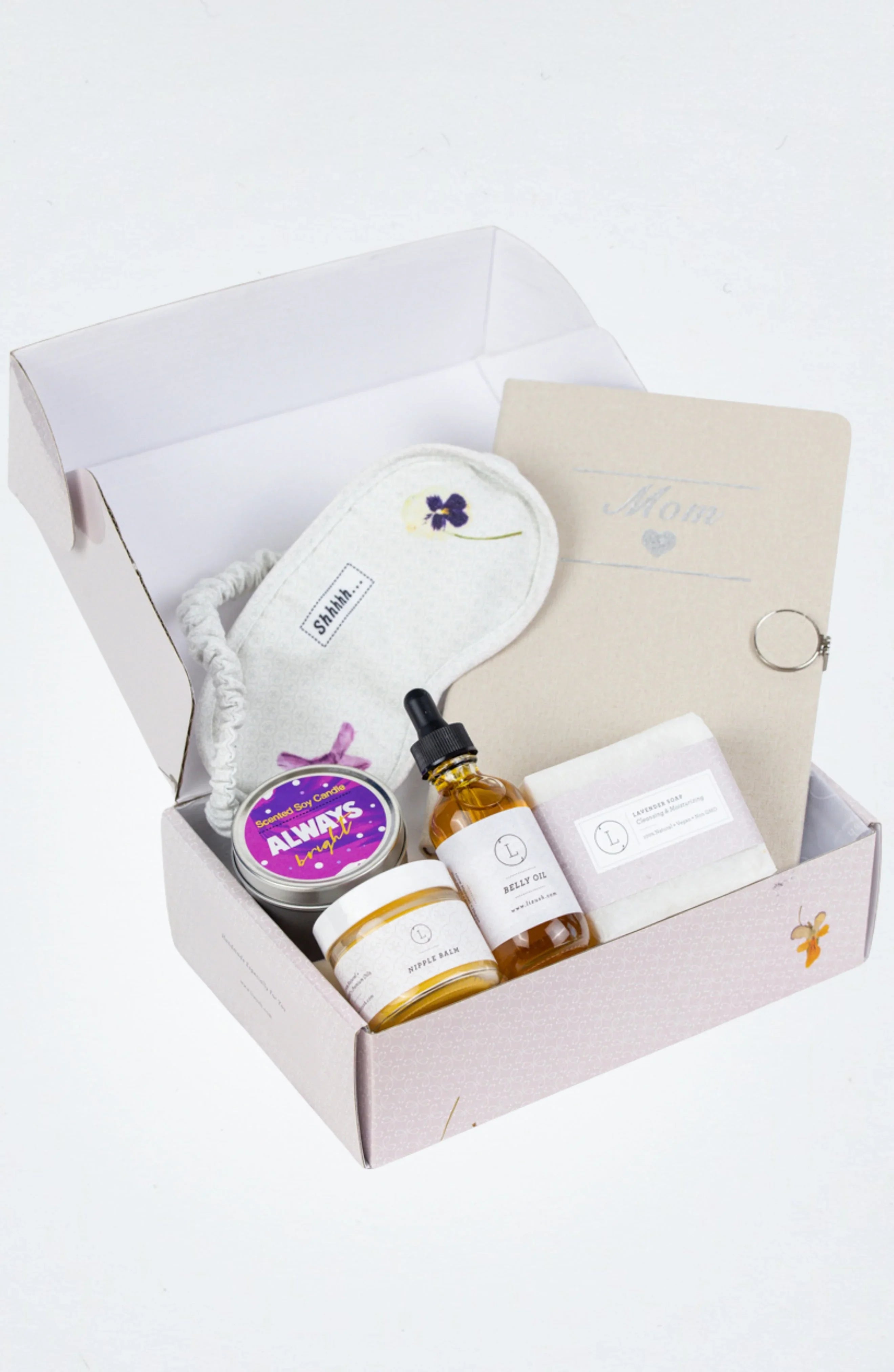 New mom gift box with scented candle, nipple balm, belly oil, lavender soap, eye mask, and mom journal