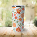 Stainless steel travel tumbler with orange floral watercolor design on wooden surface