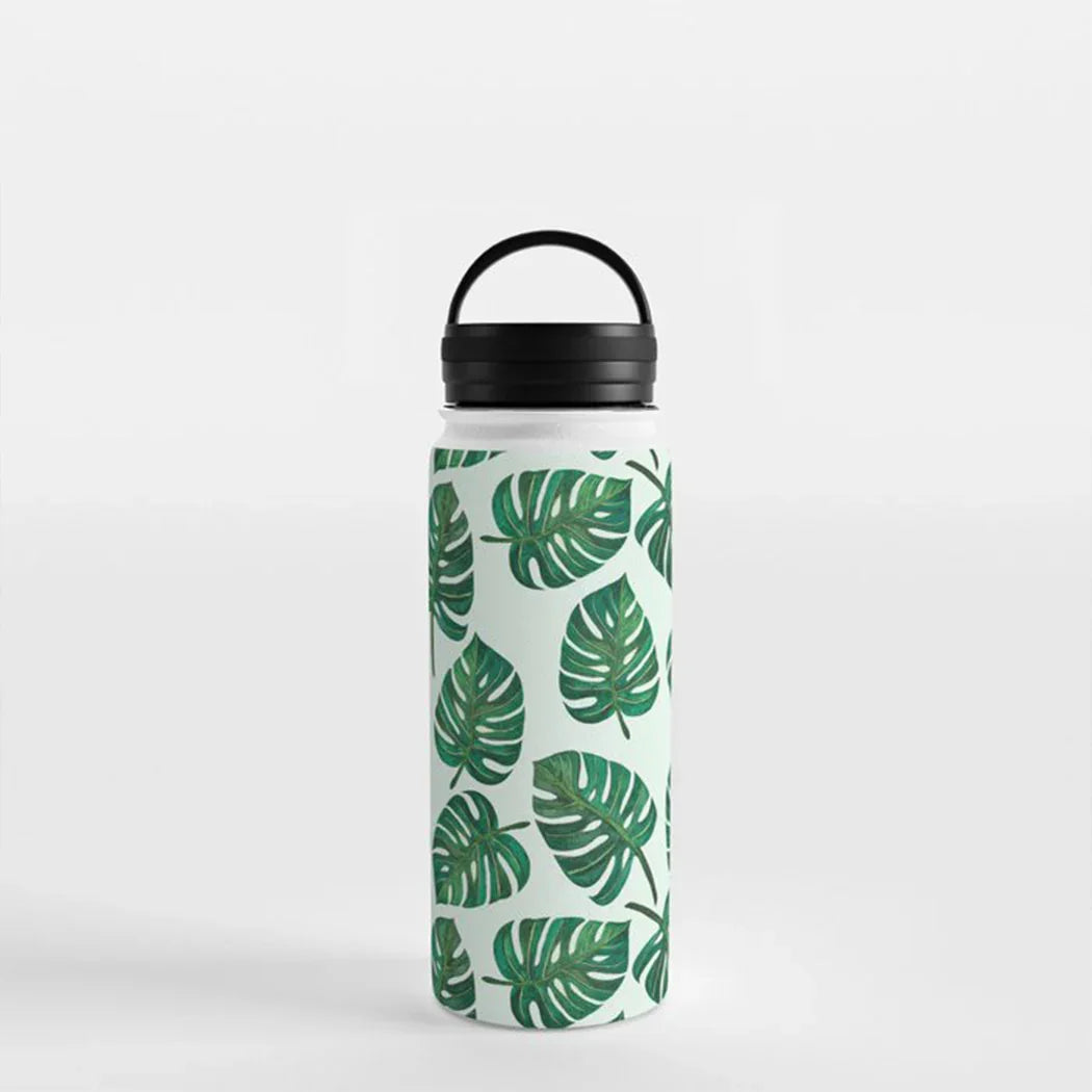 White water bottle with black lid and green tropical monstera leaf pattern