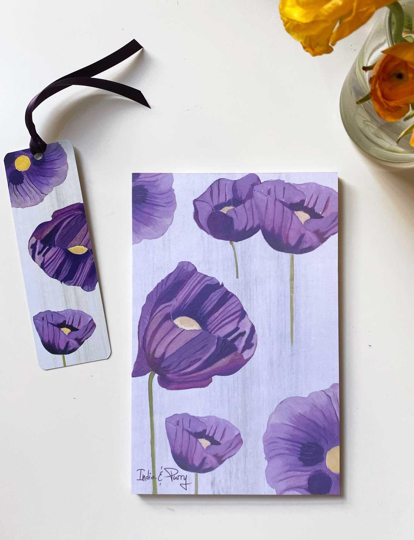 Purple poppy floral notepad and matching bookmark with black ribbon on white surface