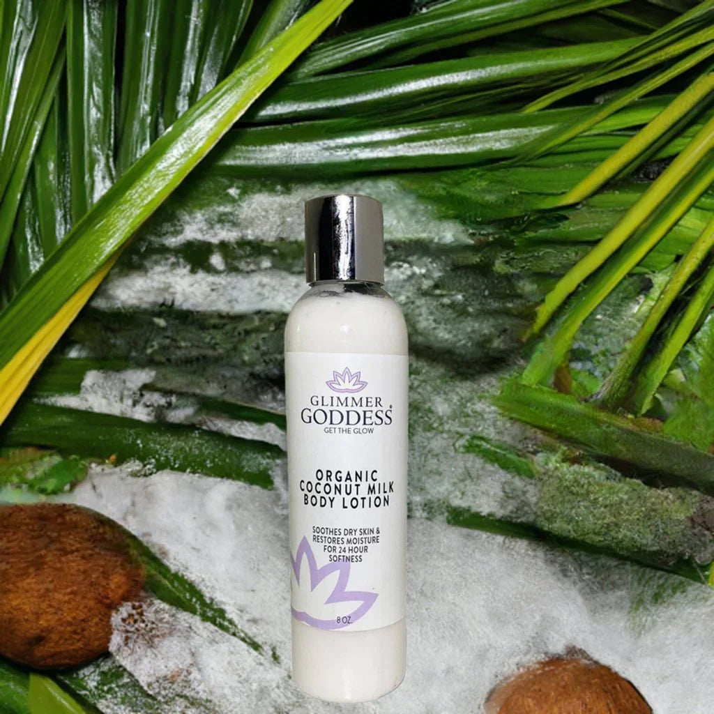 Glimmer Goddess organic coconut milk body lotion bottle on tropical leaves and coconut background
