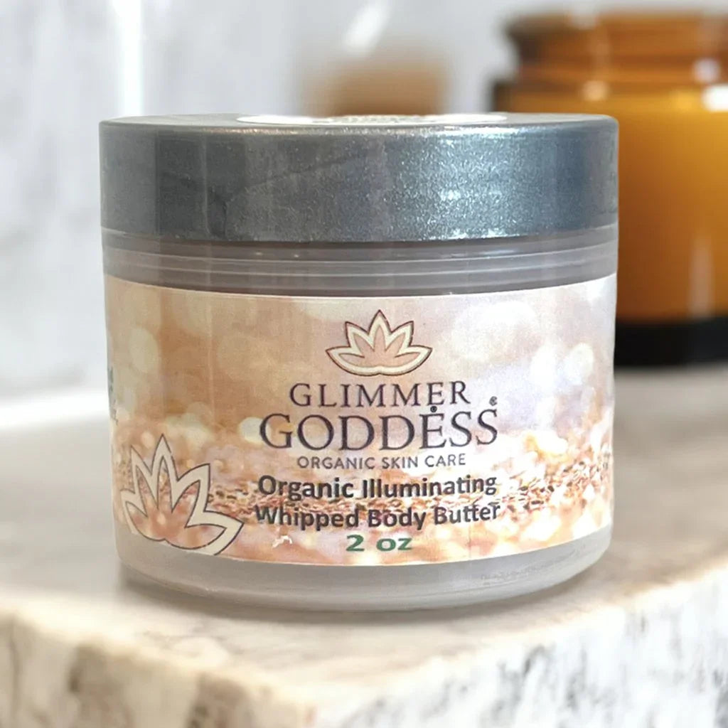 Glimmer Goddess organic illuminating whipped body butter 2 oz on marble surface in soft light