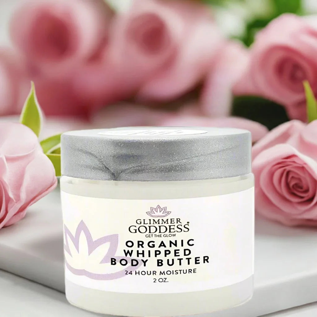 Glimmer Goddess Organic Whipped Body Butter 2 oz jar with pink roses backdrop
