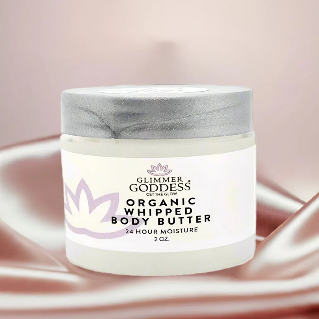 Glimmer Goddess organic whipped body butter 2 oz jar on silky satin background