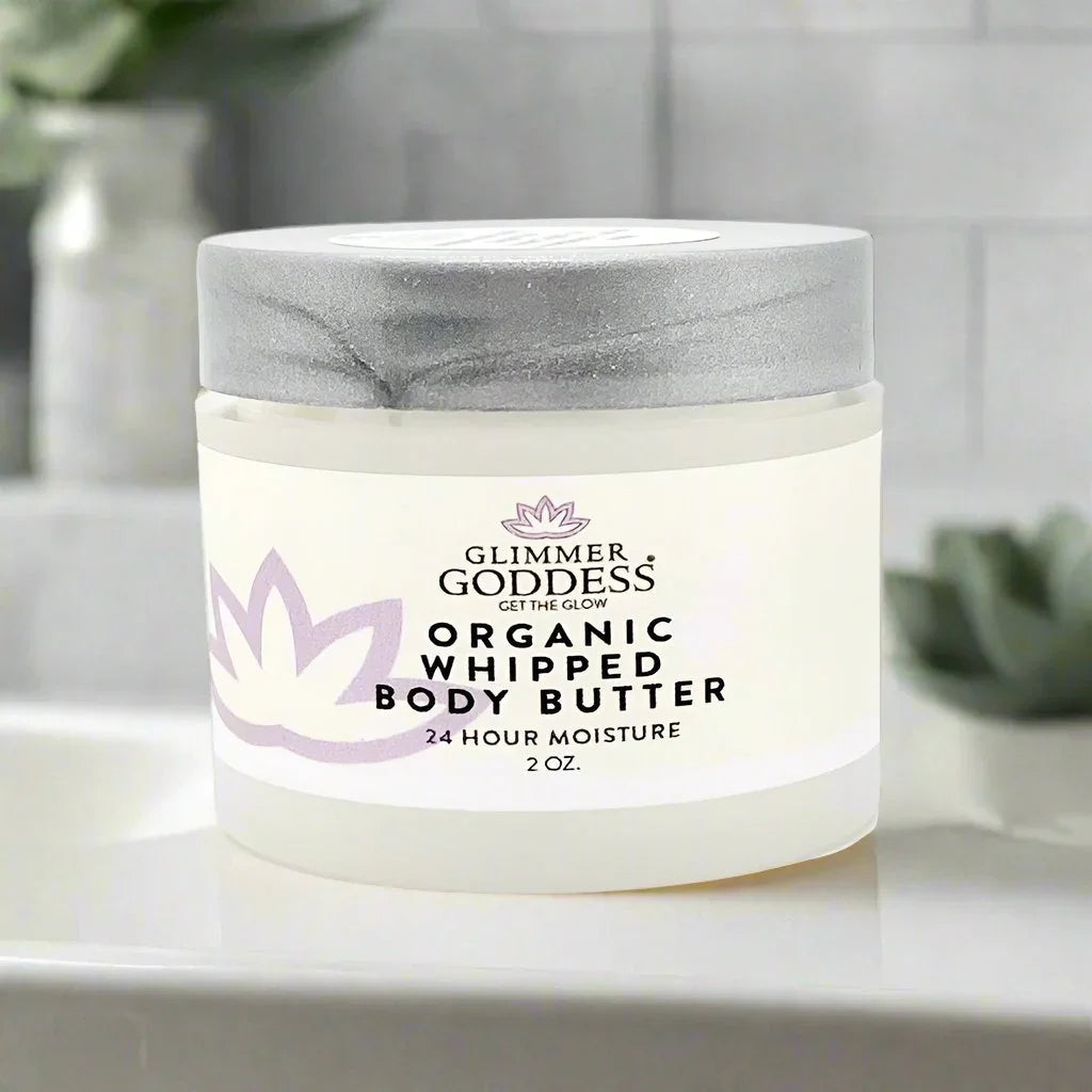 Glimmer Goddess Organic Whipped Body Butter 2 oz jar with gray lid on bathroom counter