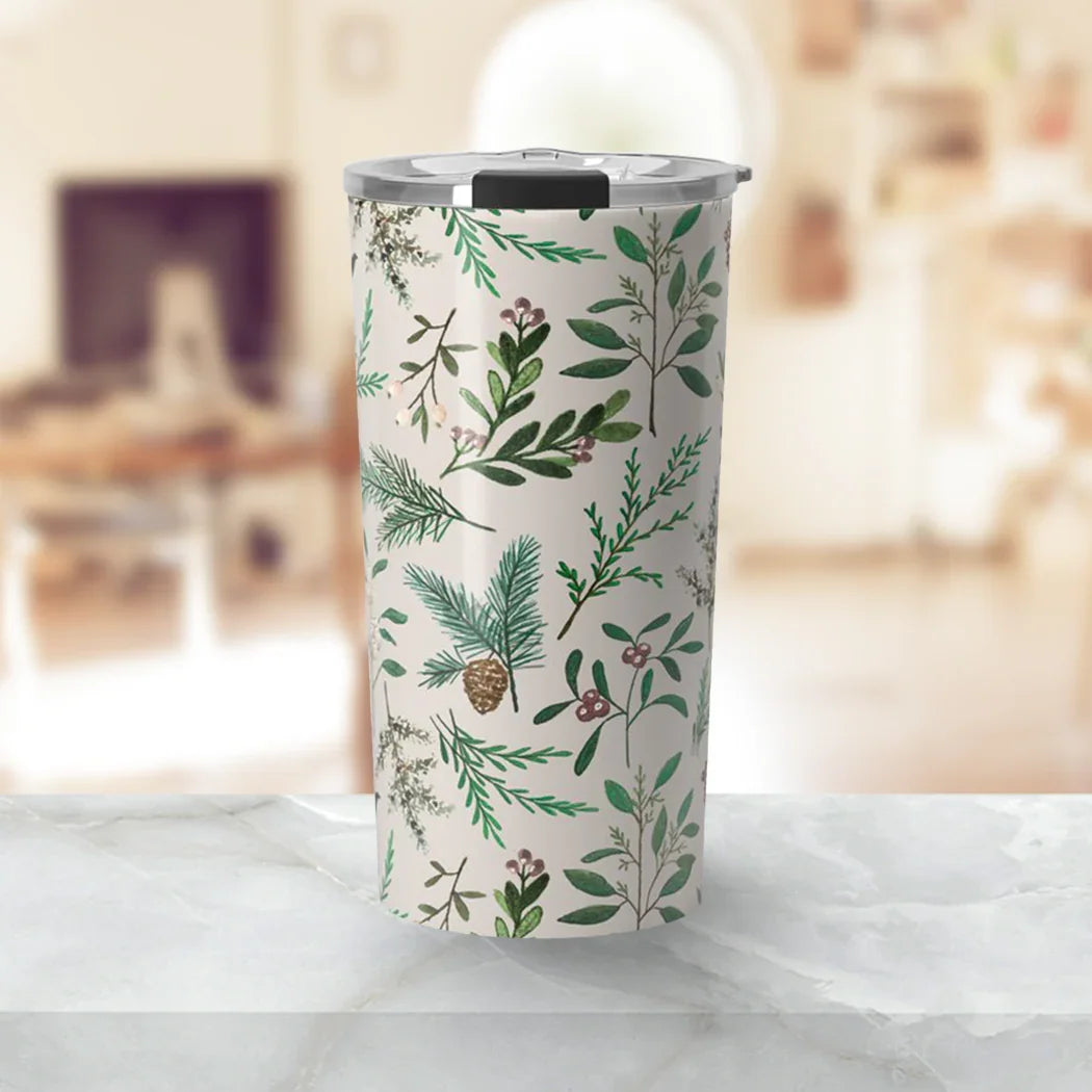 Tumbler with silver lid featuring green botanical leaf and pine cone pattern on white background