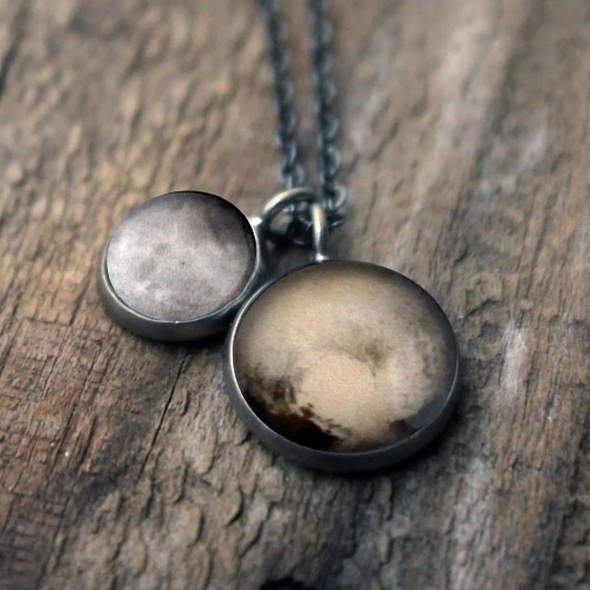 Cosmic-inspired two-pendant necklace on wood, Qu!rk Boutique artist-designed jewelry