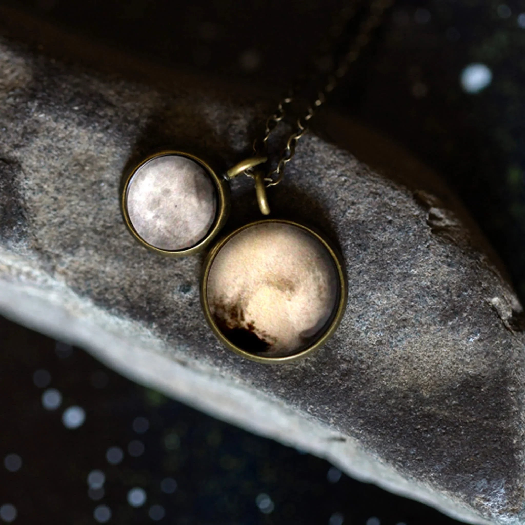 Celestial-inspired pendant necklace with two round charms on a rock, Qu!rk Boutique jewelry