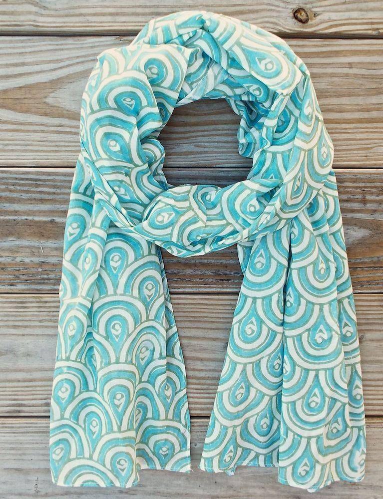 Peacock teal patterned scarf displayed on rustic wood, Qu!rk Boutique artist-designed accessory