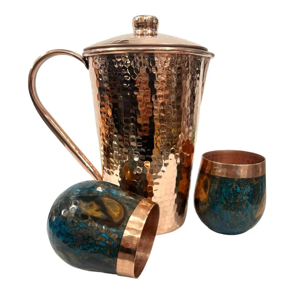 Hammered copper pitcher with lid and two patina copper tumblers from Qu!rk Boutique.