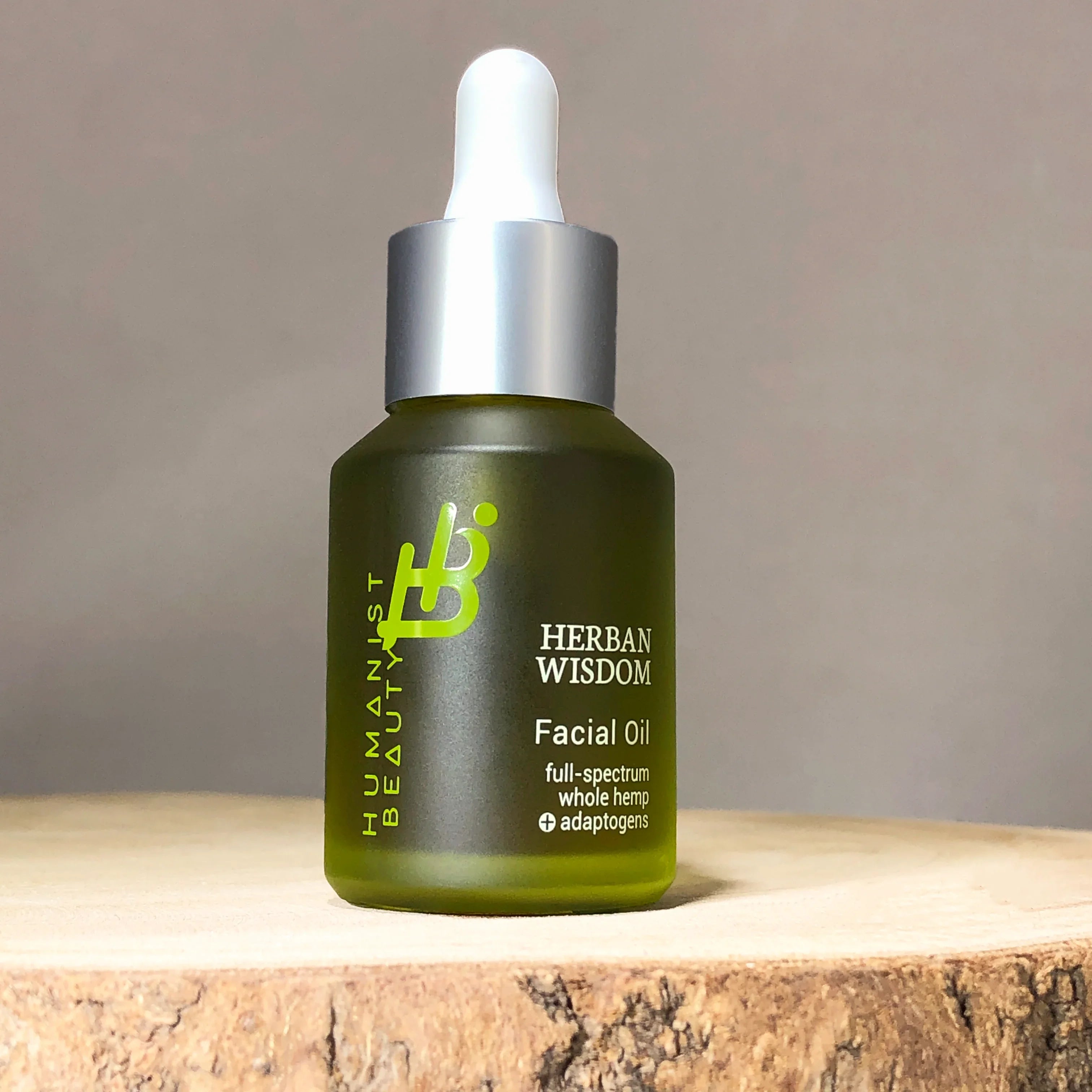 Herban Wisdom facial oil bottle with dropper on wood surface, sustainable skincare at Qu!rk Boutique