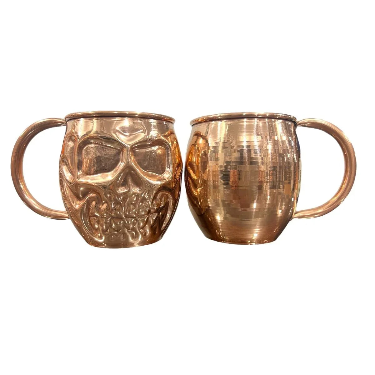 Two copper mugs, one with a skull design, from Qu!rk Boutique cosmic gift shop.