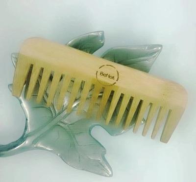 Wide-tooth wooden hair comb with Berkat logo on glass leaf-shaped dish