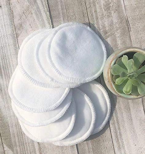 Reusable cotton rounds on wooden surface beside small succulent plant at Qu!rk Boutique
