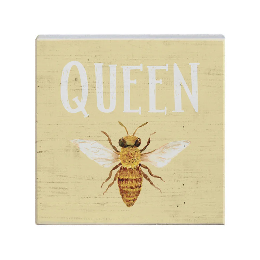 Rustic wooden sign with a painted bee and the word QUEEN in white on beige background