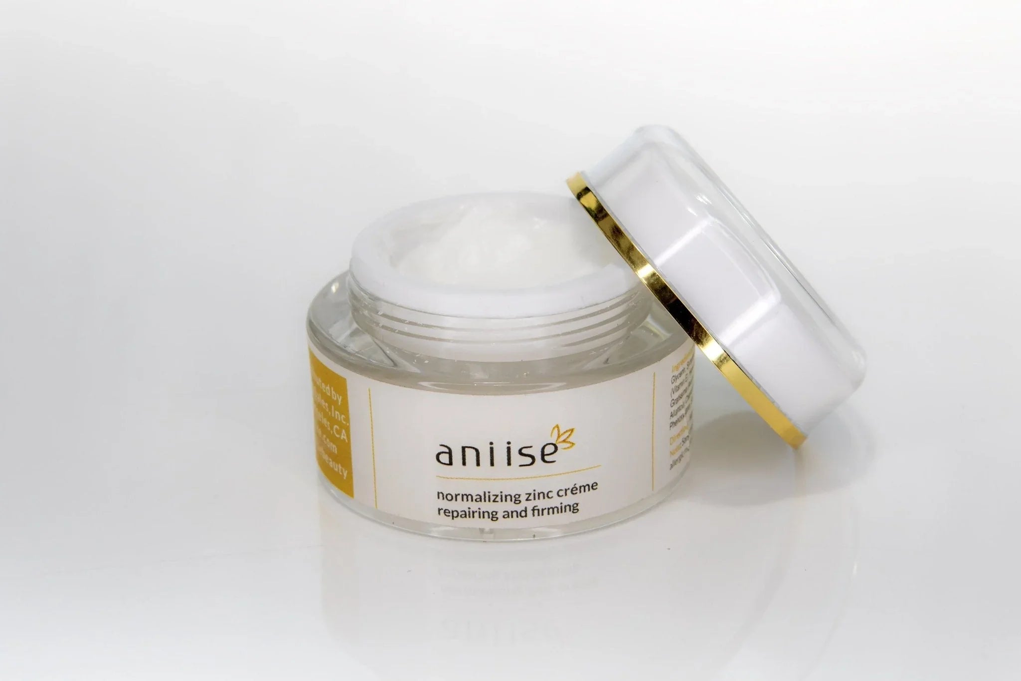 Aniise normalizing zinc cream jar with open lid, skincare product for repairing and firming
