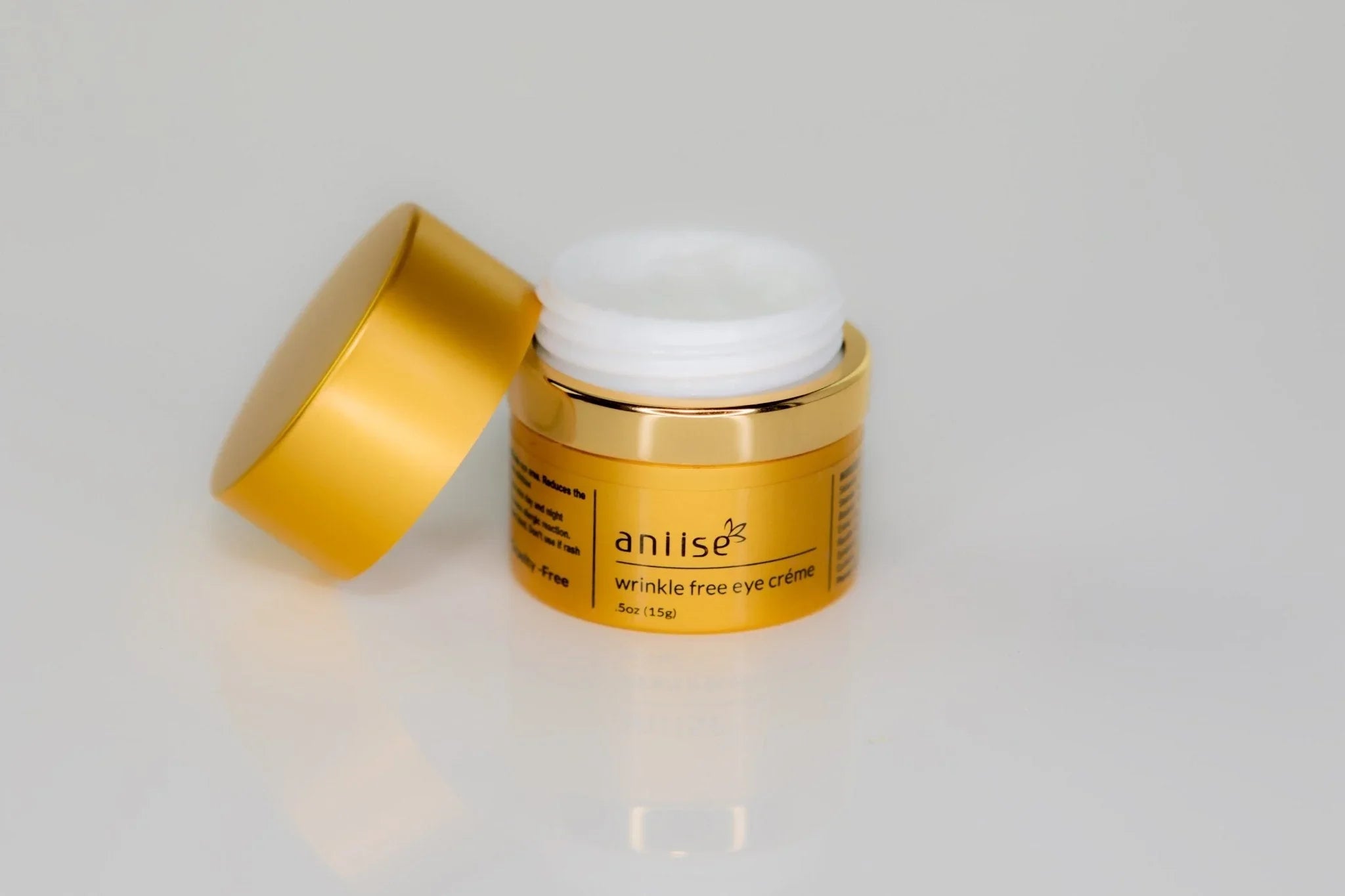 Aniise wrinkle free eye crème in gold jar, luxury skincare product on white background