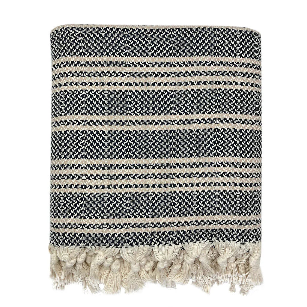 Folded black and cream striped throw blanket with fringe, Qu!rk sustainable home décor
