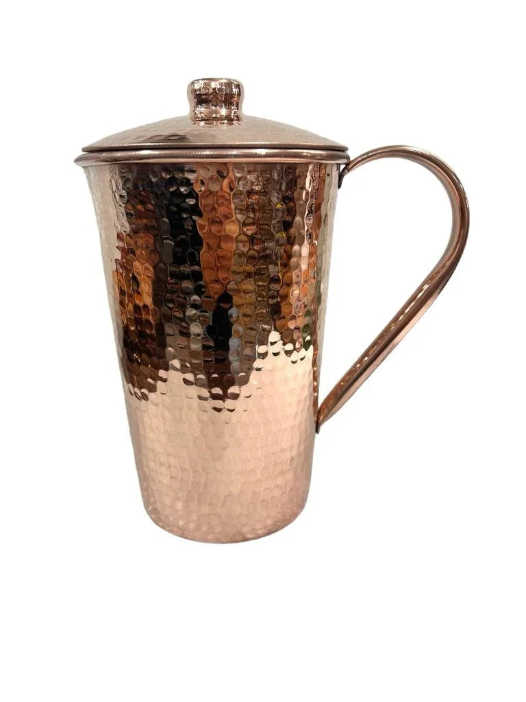 Hammered copper pitcher with lid and handle, artisan drinkware from Qu!rk Boutique.