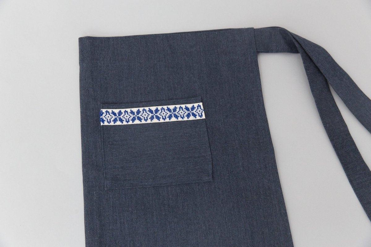 Blue apron with front pocket featuring blue and white embroidered pattern, Qu!rk Boutique