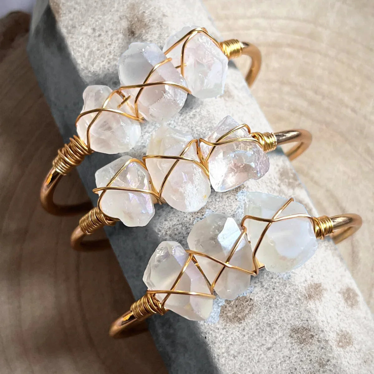 Crystal stone wire-wrapped bracelets with gold bands on a stone, Qu!rk Boutique jewelry