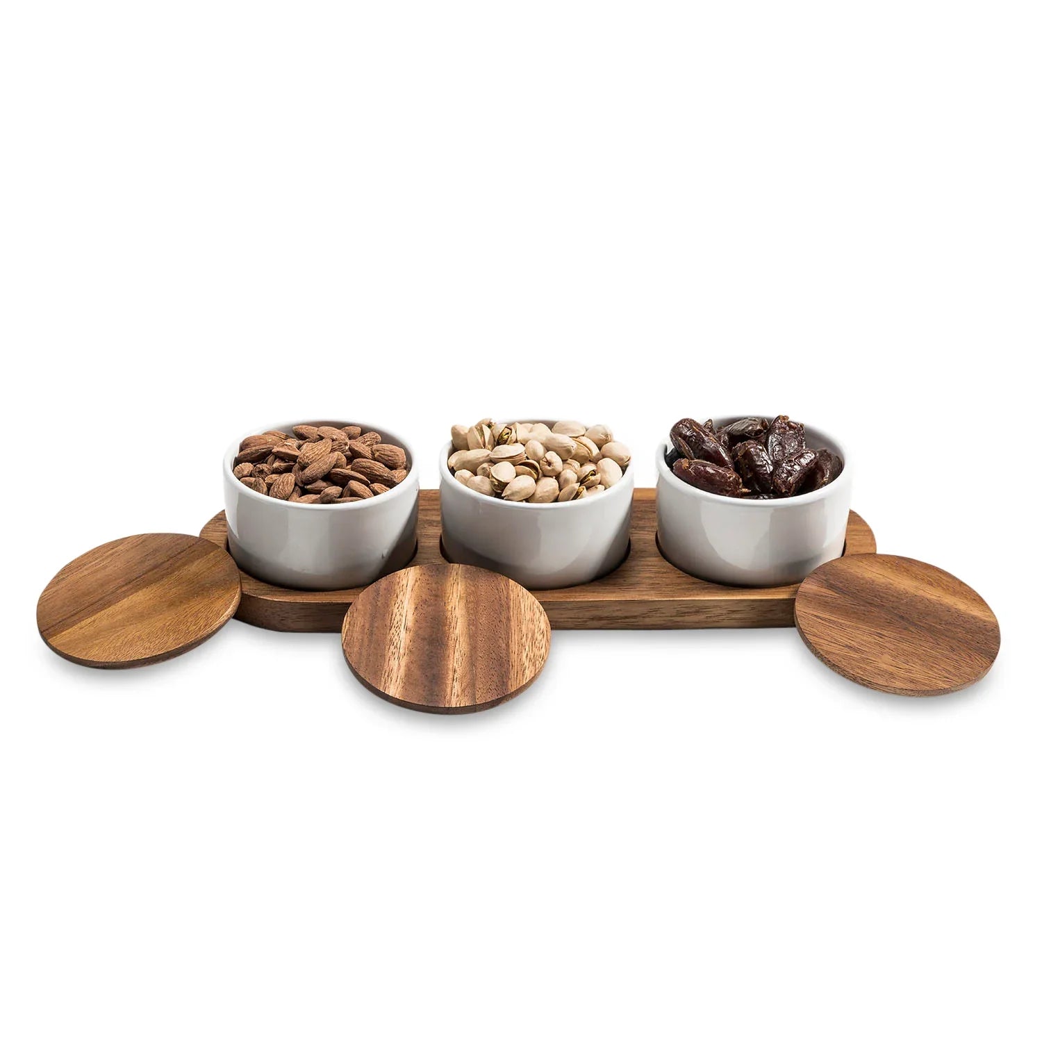 Ceramic snack bowls with acacia wood lids and tray, filled with almonds, pistachios, and dates