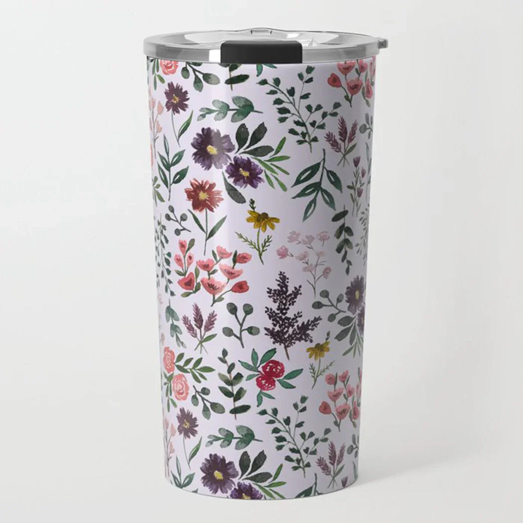Stainless steel travel tumbler with colorful floral and leafy pattern on white background