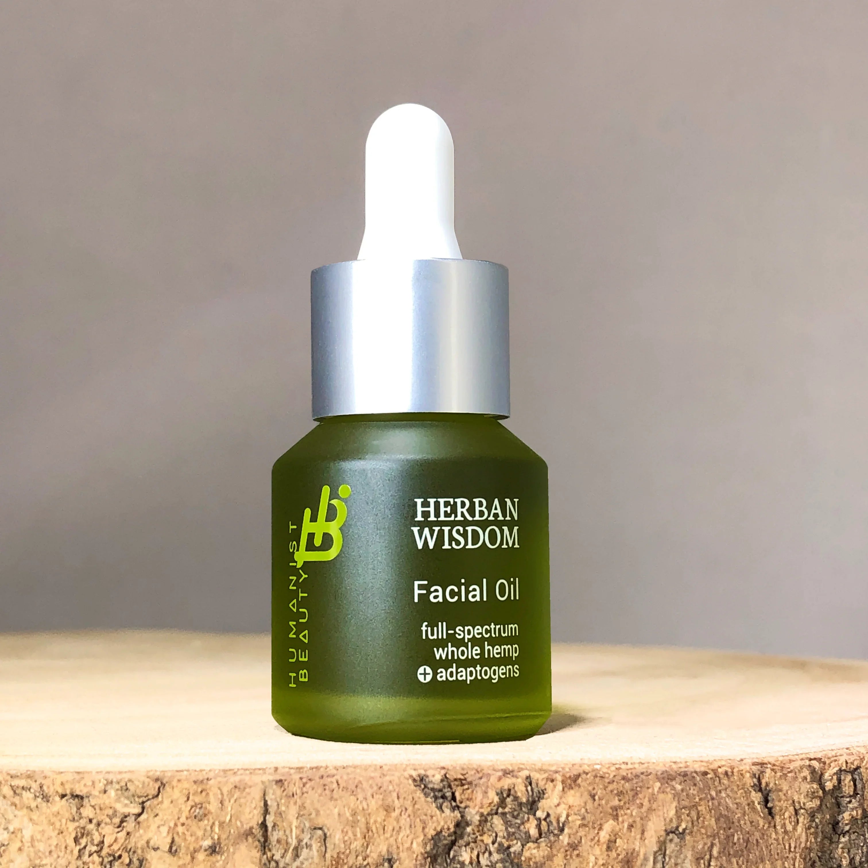 Herban Wisdom facial oil bottle with dropper on wood, eco-friendly skincare at Qu!rk Boutique