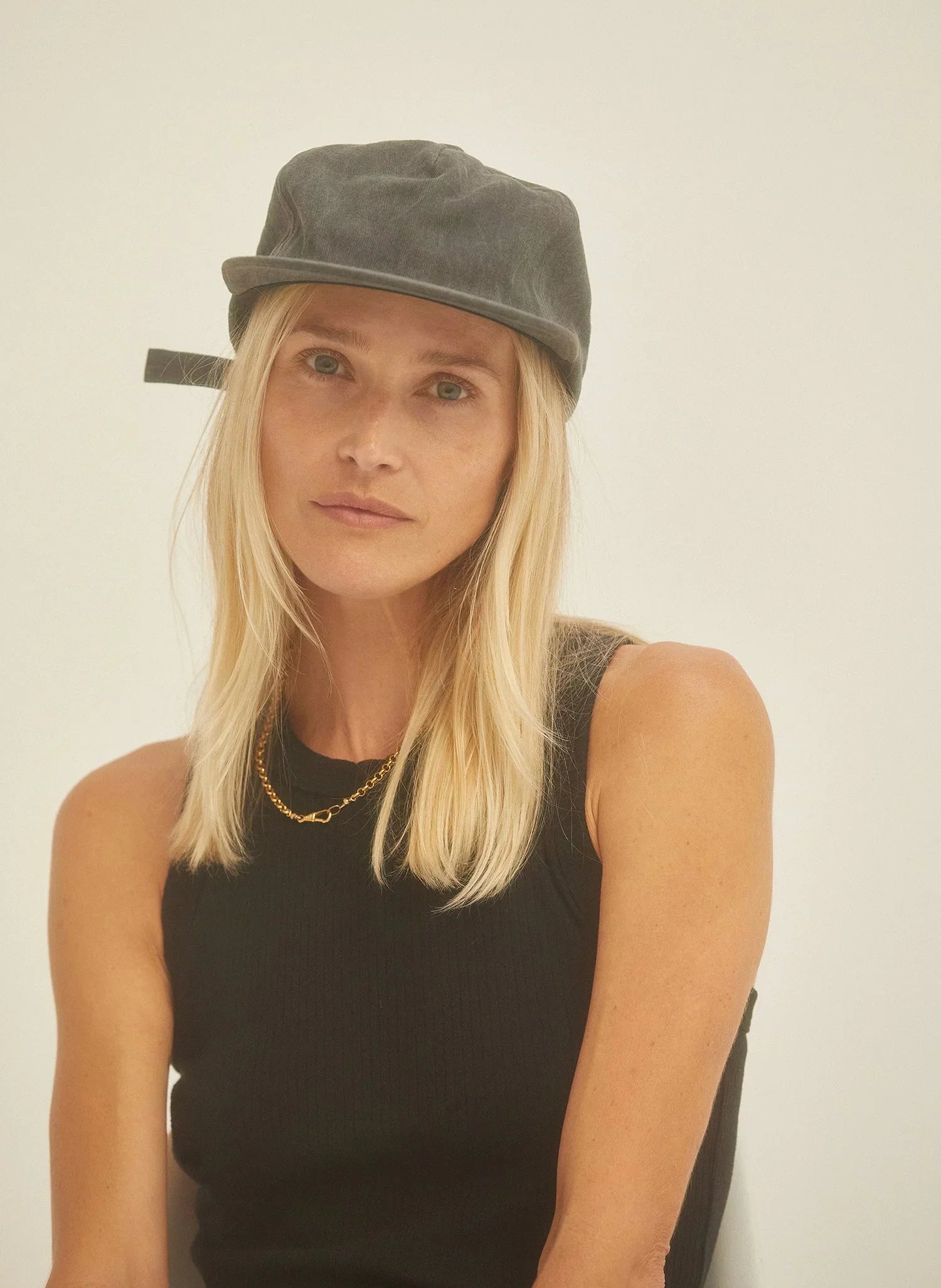 Woman in black vintage washed cotton twill field trip hat and sleeveless top at Qu!rk Boutique