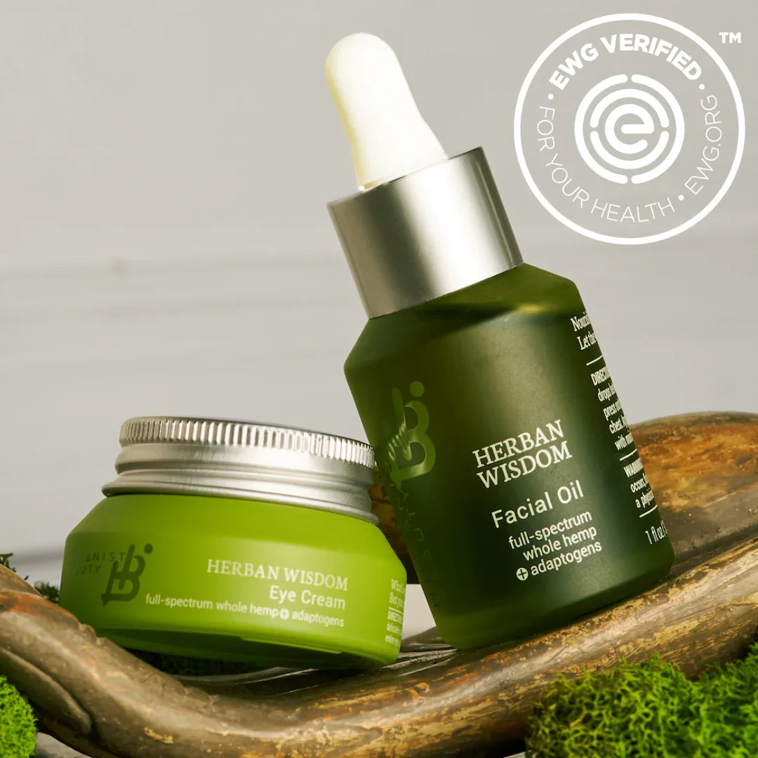 Herban Wisdom facial oil and eye cream with hemp adaptogens on wood, EWG Verified badge