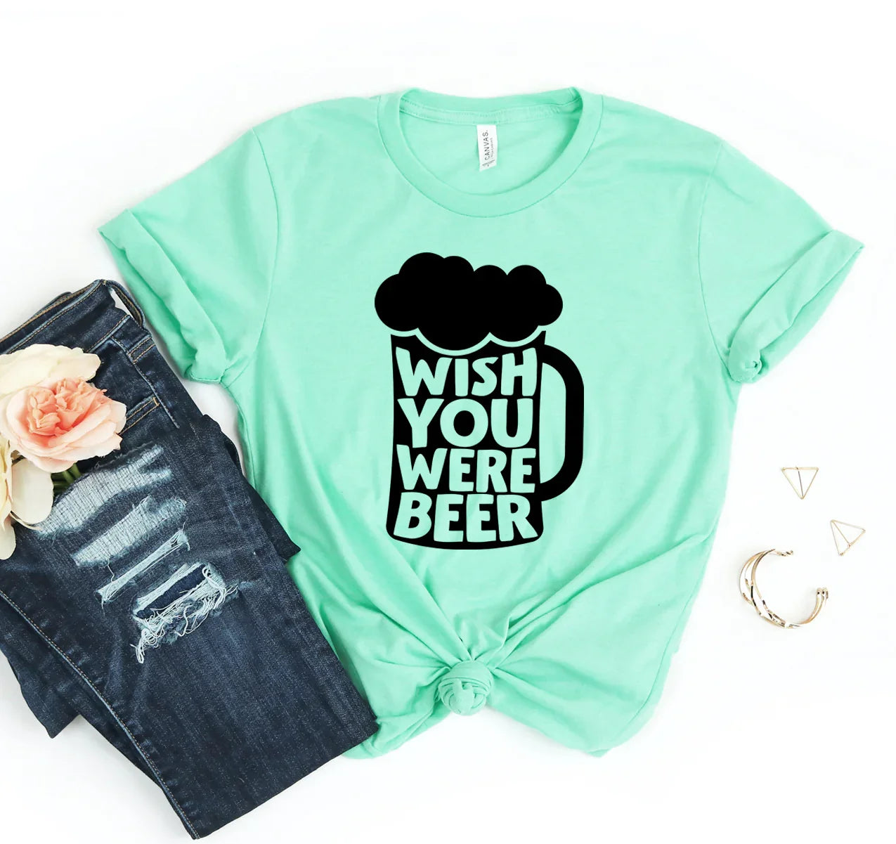 Mint green t-shirt with black beer mug graphic and text Wish You Were Beer, paired with ripped jeans