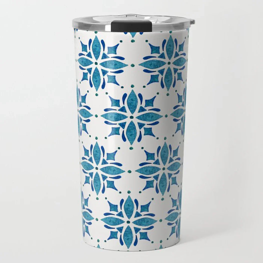 White travel tumbler with blue geometric floral pattern and silver lid