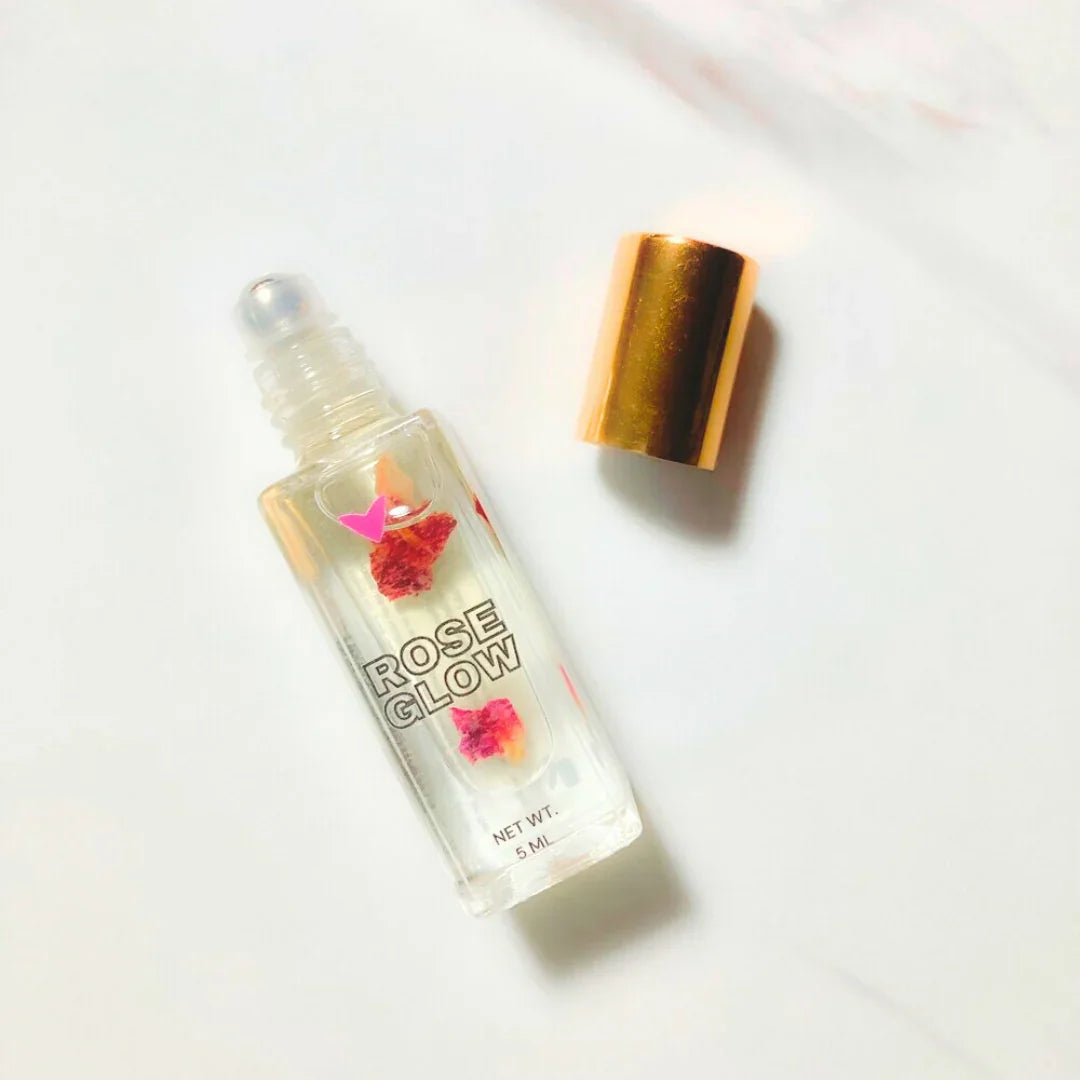 Rose Glow roll-on perfume oil with gold cap on white background, Qu!rk Boutique gift item